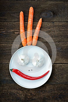 Smiley face made from pepper, garlic,flavoring and carrots