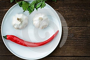 Smiley face made from pepper, garlic and parsley