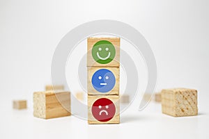 smiley face on wood block cube - business services rating customer experience, Satisfaction survey concept - Feedback photo