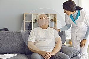 Friendly doctor or helpful nurse comes to see senior patient at home or in assisted living facility photo