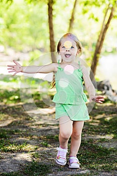 Smiley little girl having fun with bubble blower