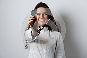 Smiley woman doctor surgeon with stethoscope on white background. Professional medecine. advert for medical clinic.