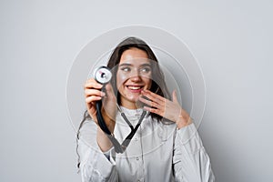 Smiley woman doctor surgeon with stethoscope on white background. Professional medecine. advert for medical clinic.