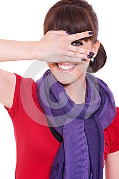 Smiley woman looking through her fingers