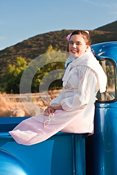 Smiling 1950s teen girl in pickup truck