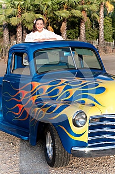 Smiling 1950s teen girl in pickup truck