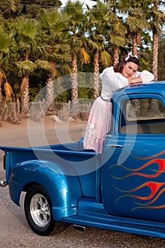 Smiling 1950s teen girl in pickup truck