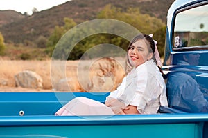 Smiling 1950s teen girl in pickup truck