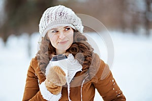 Smiling 40 years old woman outside in city park in winter