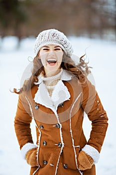 Smiling 40 years old woman outside in city park in winter