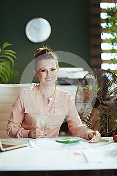 smiling 40 years old woman worker in green office