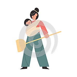 Smiling active young mother doing housework with small baby sitting in sling