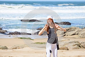 Smiling active young woman ready for sport excercises on the beach