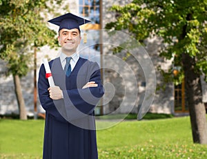 Smiling adult student in mortarboard with diploma