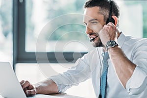 smiling adult support hotline worker with laptop