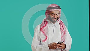 Smiling adult typing messages on phone