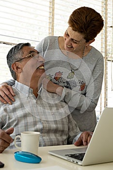 Smiling Affectionate Couple Using A Laptop