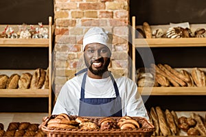 smiling african american baker holding basket