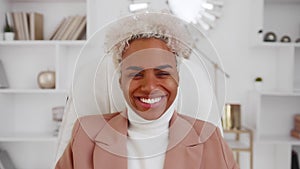 Smiling African American business woman looking at camera posing at home office