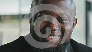 Smiling african american businessman employee company founder looking at camera bearded male office worker successful