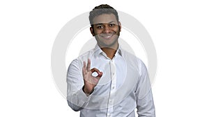 Smiling african-american businessman showing OK sign.