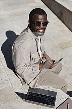 Smiling African American Businessman in Sunlight