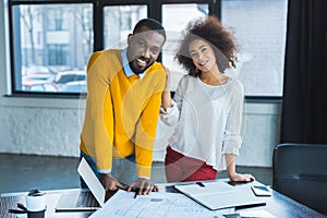 smiling african american businesspeople looking