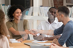 Smiling African American businesswoman handshaking with business partner