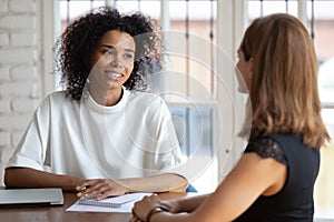 Smiling African American businesswoman hr manager holding interview with applicant