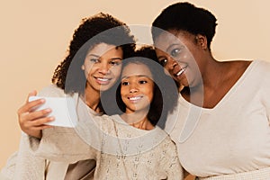 smiling african american daughter, granddaughter and