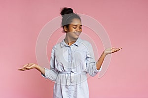 Smiling african american girl demonstrate something on her empty palms