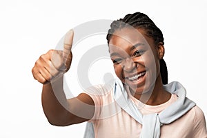 Smiling African American Girl Gesturing Thumbs-Up Over White Background