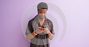 Smiling african american guy holding smartphone