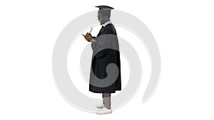 Smiling african american male student in graduation robe with di