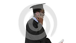 Smiling african american male student in graduation robe talking