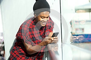Smiling african american man looking at mobile phone