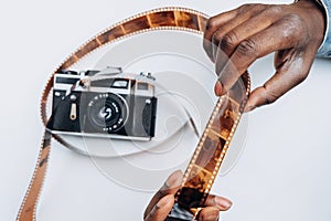 Smiling African-American man looks at photos on film in room