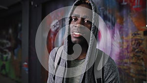 Smiling African American man portrait in underground place looking at camera