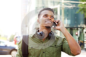 Smiling african american man talking on cellphone in the city