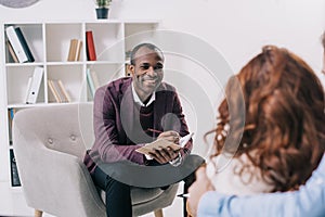 Smiling african american psychiatrist talking to