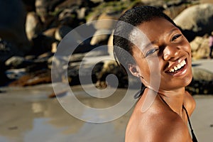 Smiling african american woman at the beach