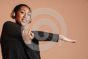 Smiling african american woman doing exercise while working out