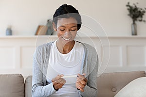 Smiling african American woman happy with positive pregnancy test