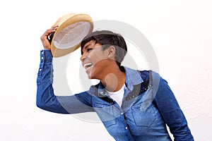 Smiling african american woman holding hat