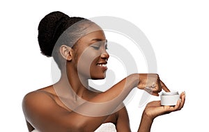 Smiling african american woman with moisturizer