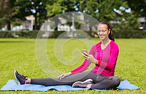 Smiling african american woman with smartphone