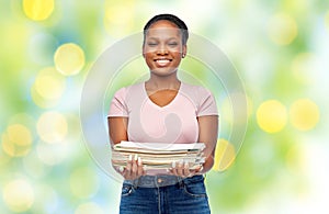 smiling african american woman sorting paper waste