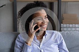 Smiling African American woman talk on cellphone