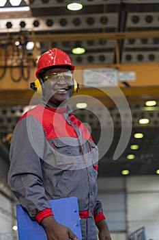 Smiling African American Worker In Personal Protective Equipment Holding Clipboard And Looking At Camera