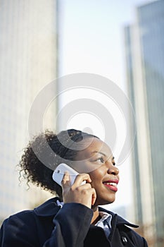 Smiling African American young woman using mobile phone